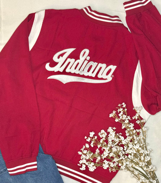 Red bomber jacket with 'Indiana' script text on the back